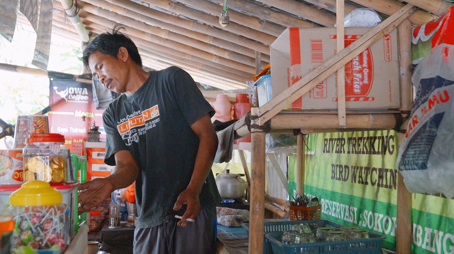 ak Tasuri at his kedai kopi, where he serves the village’s shade-grown Robusta coffee.